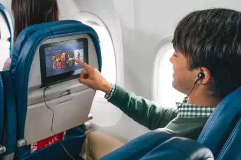 a man listening his favourite song on plane